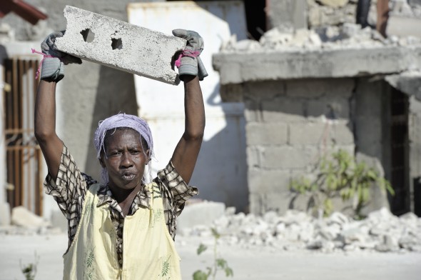 Silvani Joseph, 48, survived the January 12, 2010, earthquake and carries debris as she and her neighbors begin to build temporary shelters in the Port-au-Prince neighborhood of Belair.