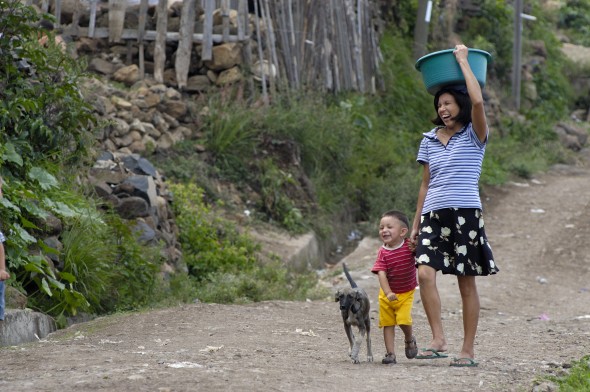 A woman and her son walk through the Fuerzas Unidas neighborhood in Tegucigalpa, the capital of Honduras.